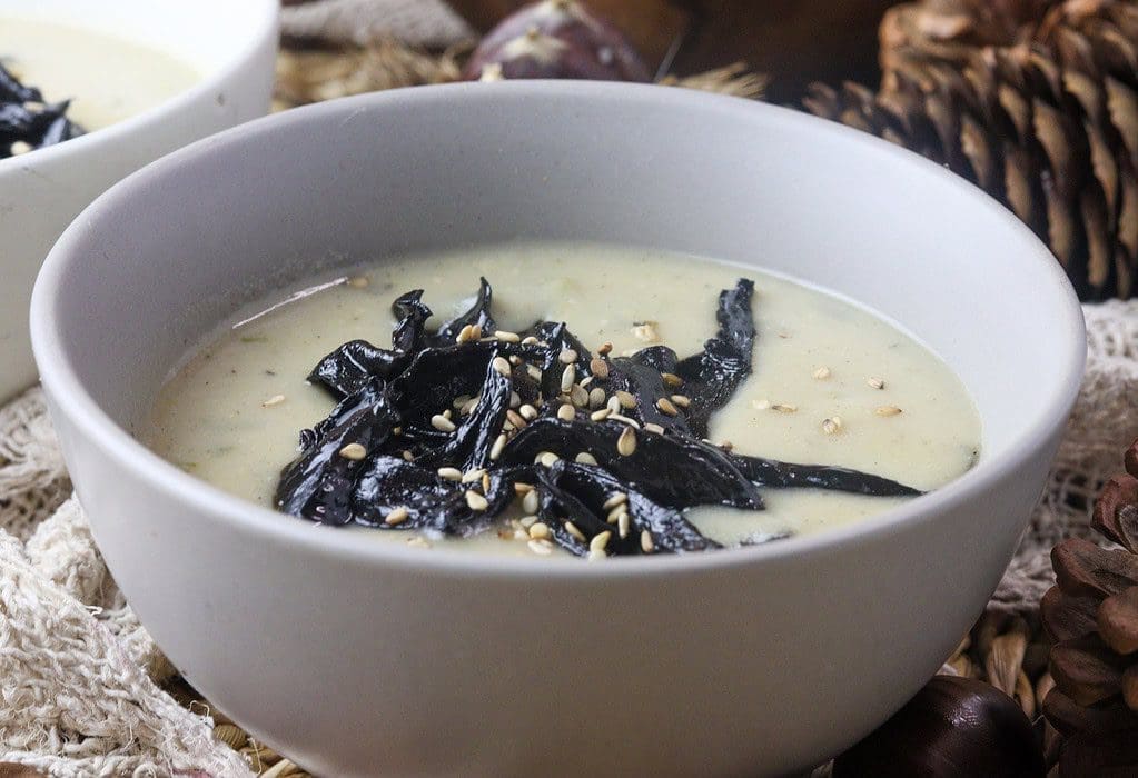 delicous pear potato soup with black trumpet mushrooms served in a bowl